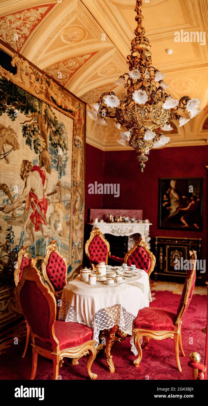 Interior of villa Monastero. Lake Como, Italy. The interior of the royal  castle in the red style. Antique furniture, paintings a Stock Photo - Alamy, image size:713x1390