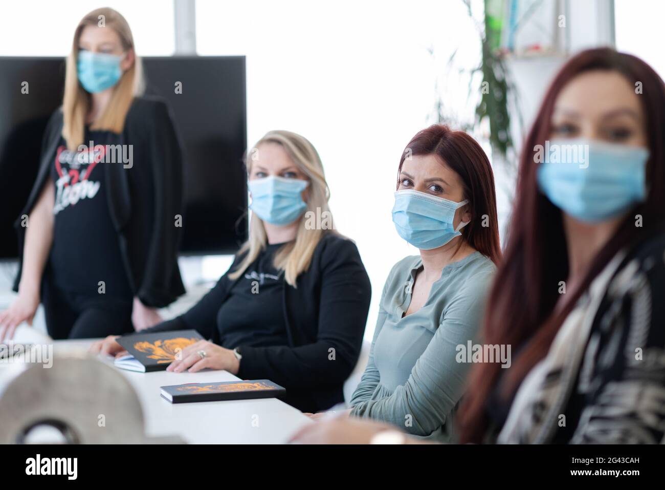 Real business people on meeting wearing protective mask Stock Photo