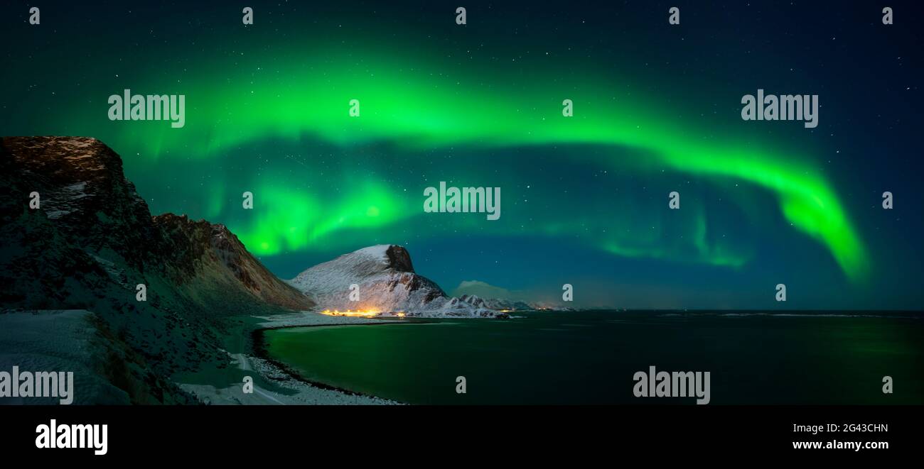 Aurora borealis above Nordlandsnupen mountain and coastline, Vaeroy, Lofoten, Norway Stock Photo