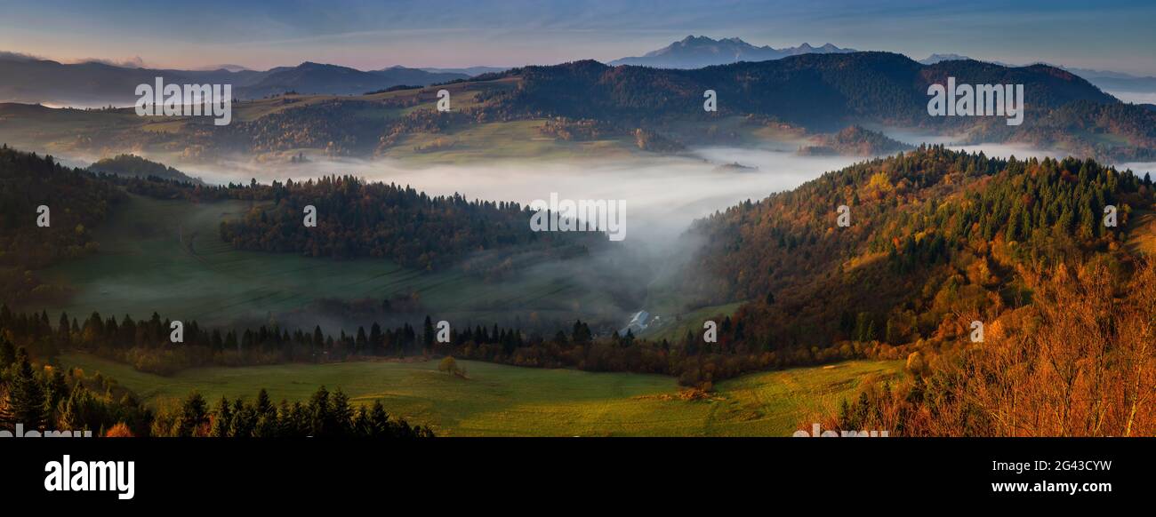 Landscape with fog, Pieniny and Tatra Mountains at sunrise, Lesser Poland Voivodeship, Poland Stock Photo