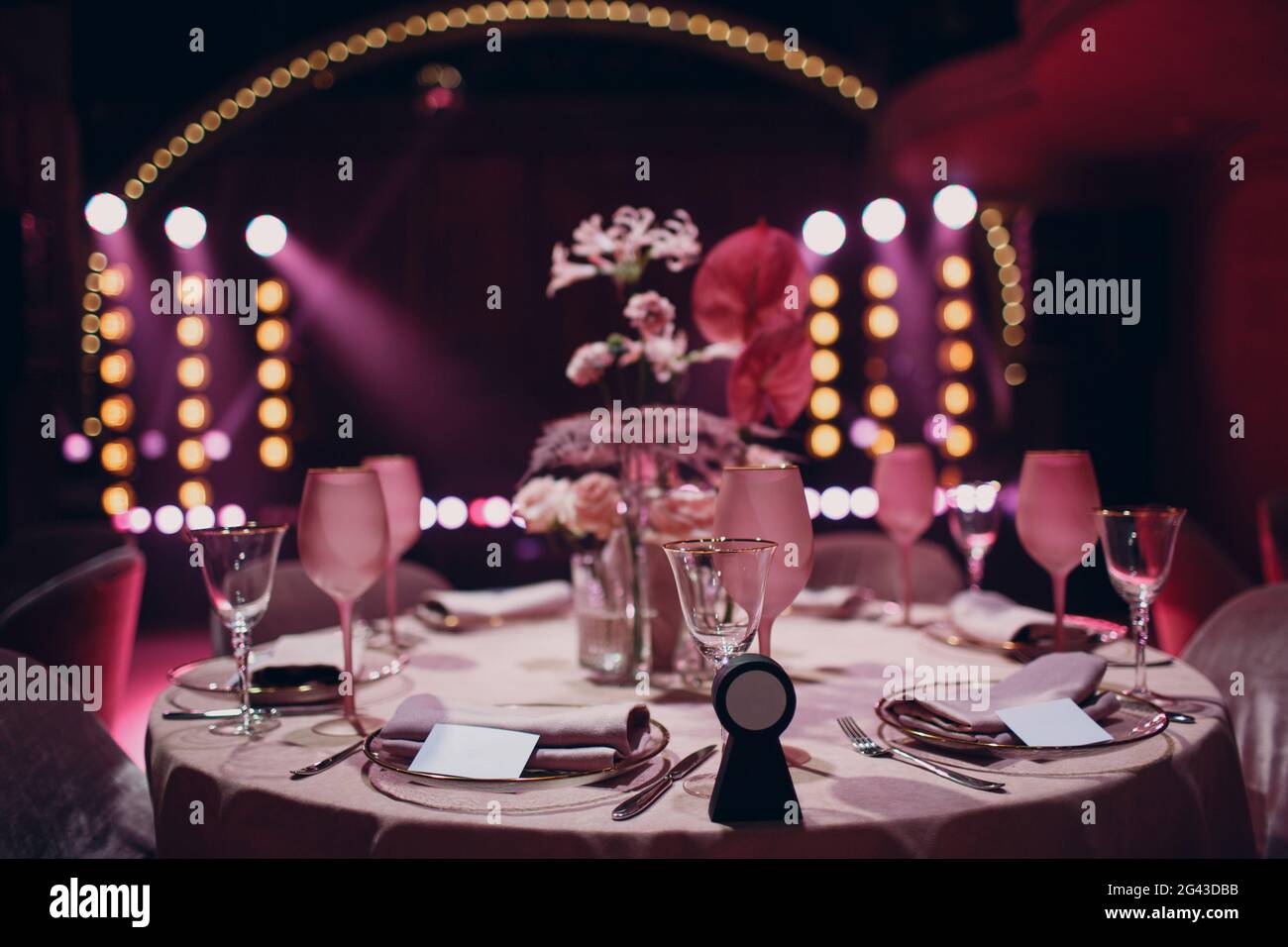 Romantic dinner pink decor table at restaurant with stage Stock Photo