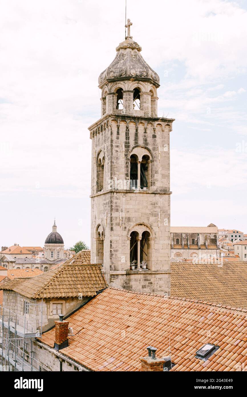 The bell tower of the Dominican monastery on the background of modern Dubrovnik, Croatia. Stock Photo