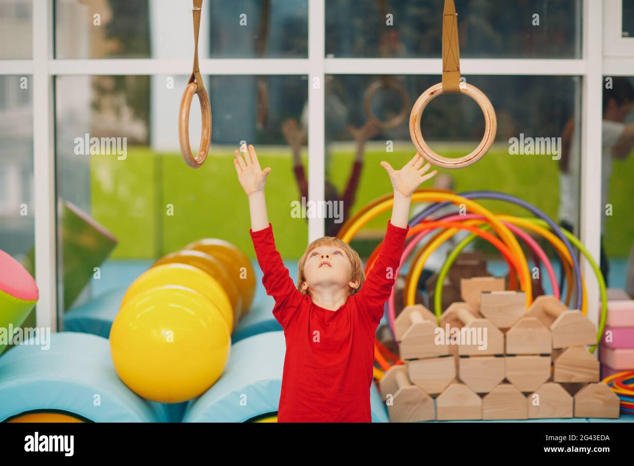 Kids doing exercises in gym at kindergarten or elementary school