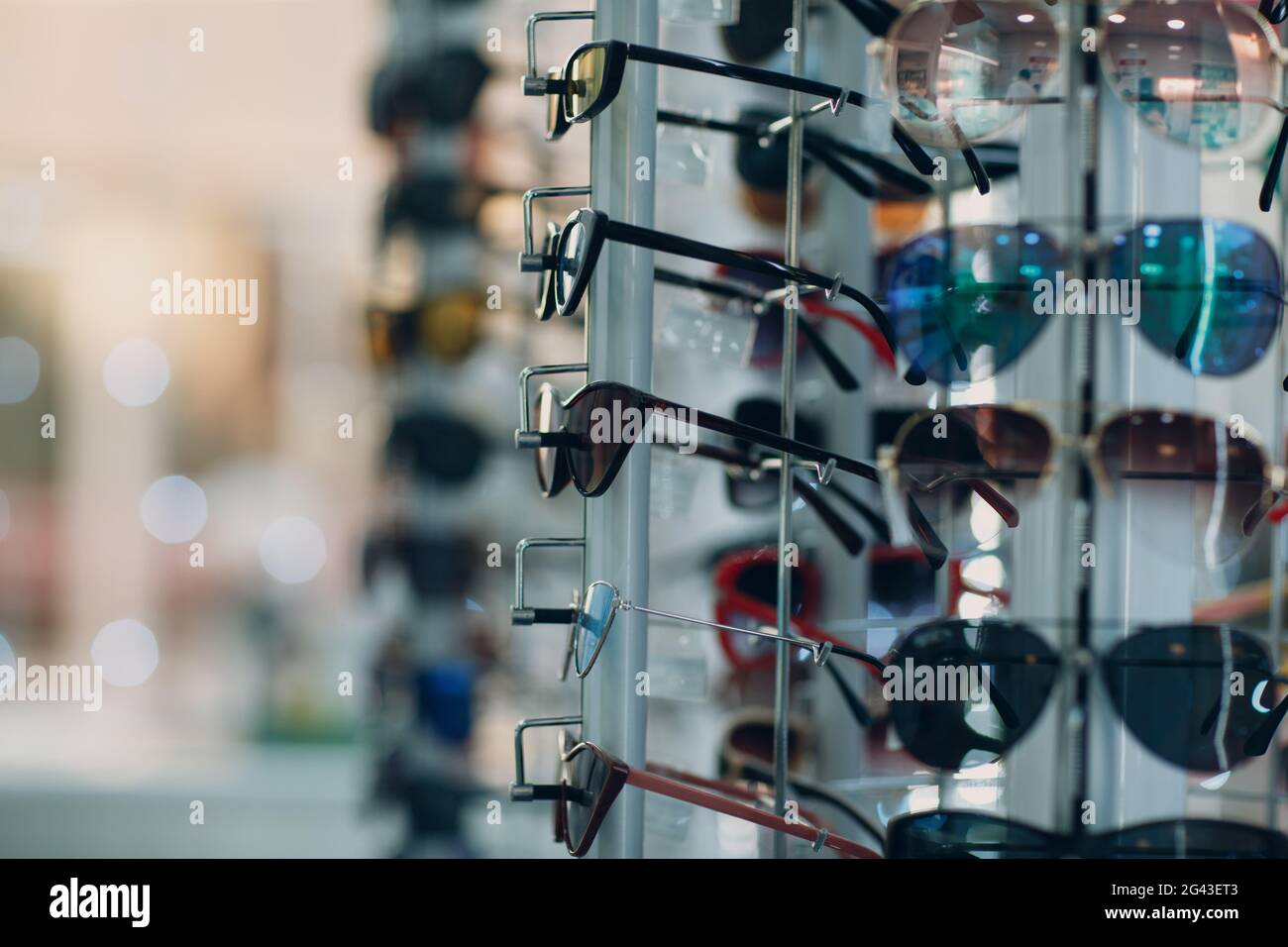 Glasses on the counter in the optics store. Eyeglasses goggles sunglasses on shop. Stock Photo