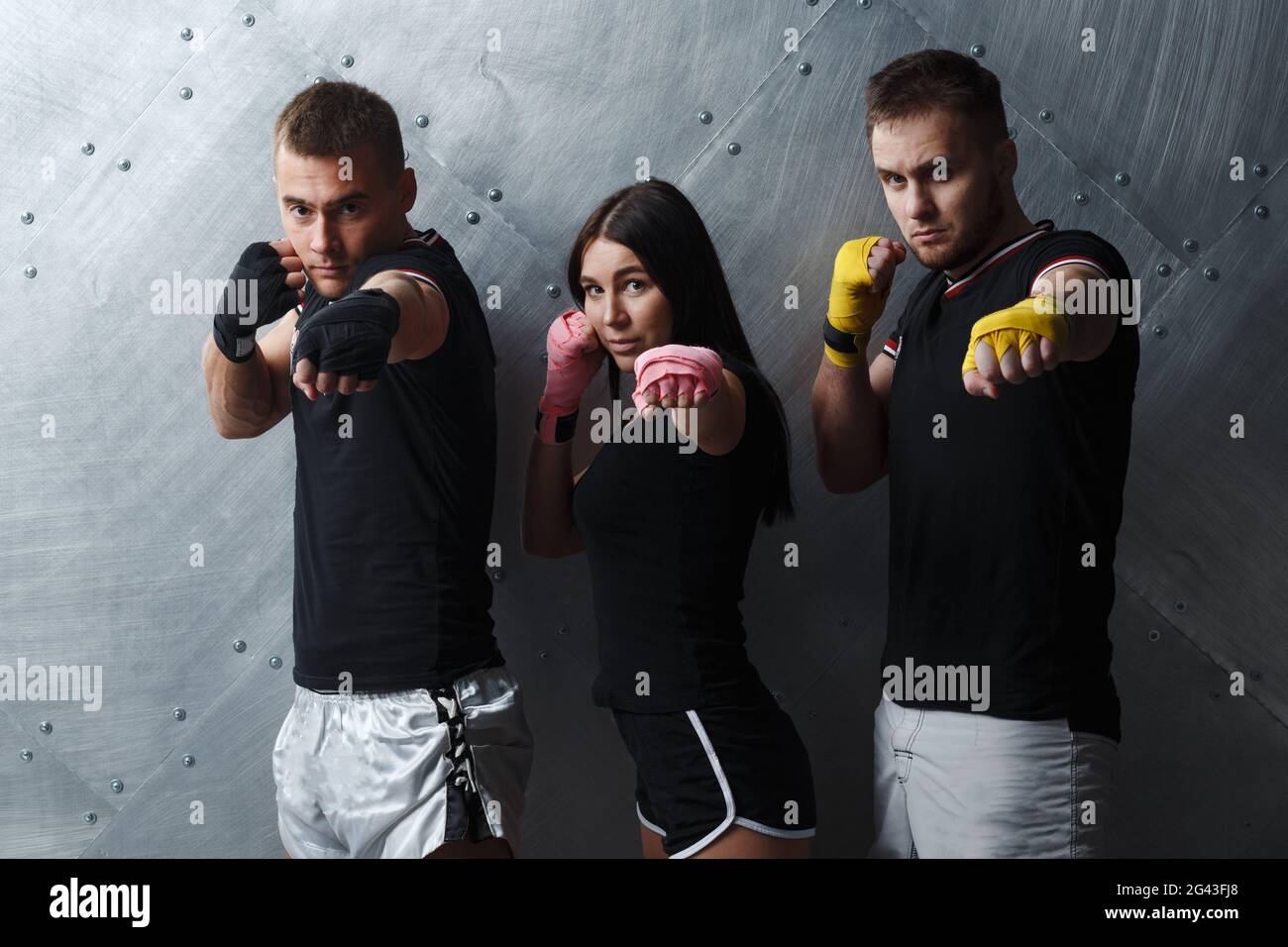 Three boxers man and woman posing before fighting muay thai boxing