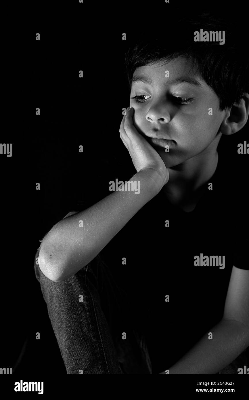 Close-Up monochrome portrait of sad boy Looking Away Stock Photo
