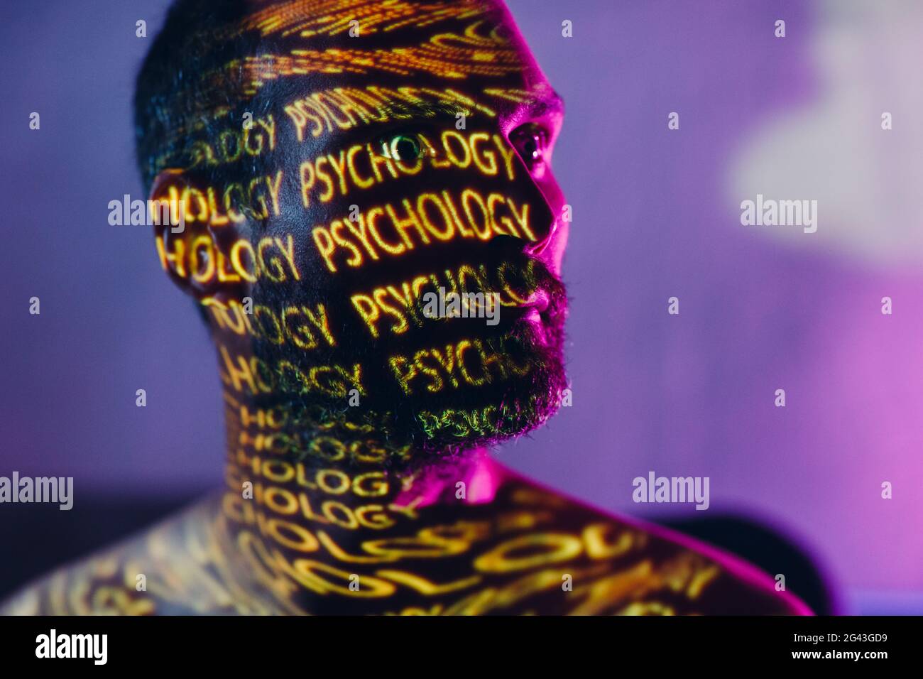 Young adult man with words Psychology on his face in the dark. Stock Photo