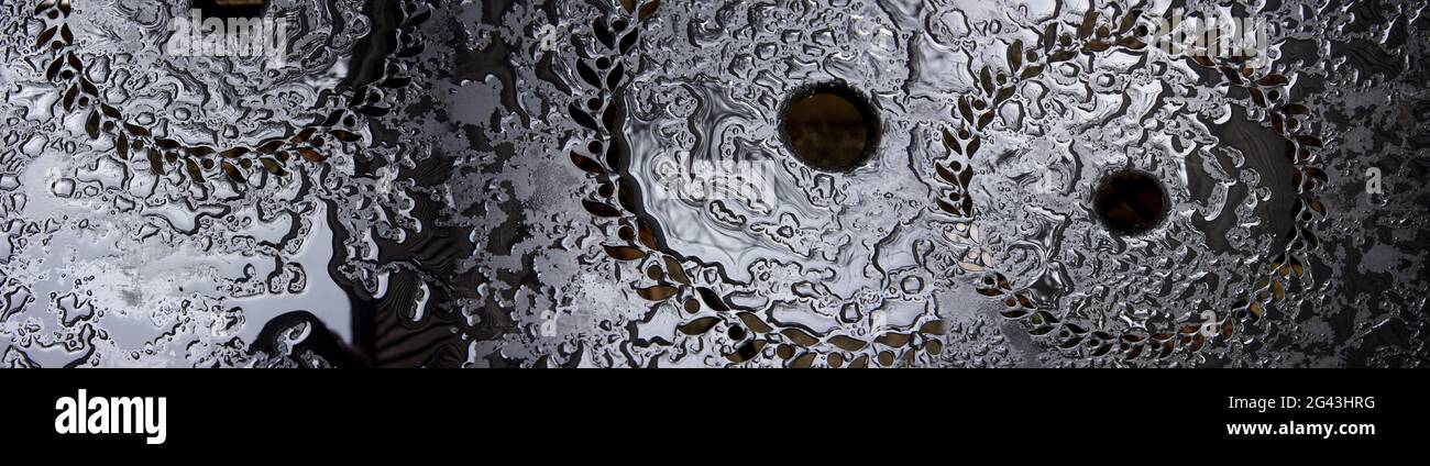 Close-up of rain drops on black table Stock Photo