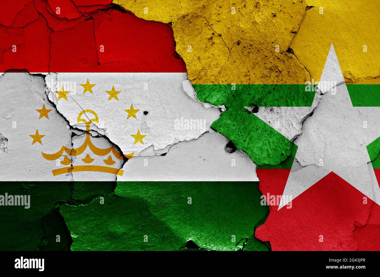 Flags of Tajikistan and Myanmar painted on cracked wall Stock Photo