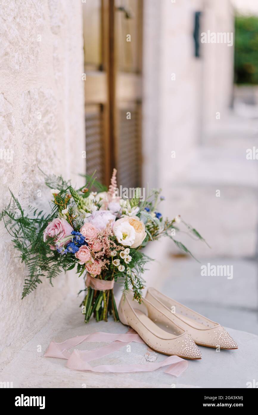 Bridal bouquet of cream roses, pink peonies, eustoma, waxflower, astilbe, limonium, branches of eucalypt tree, mattiola, asparag Stock Photo