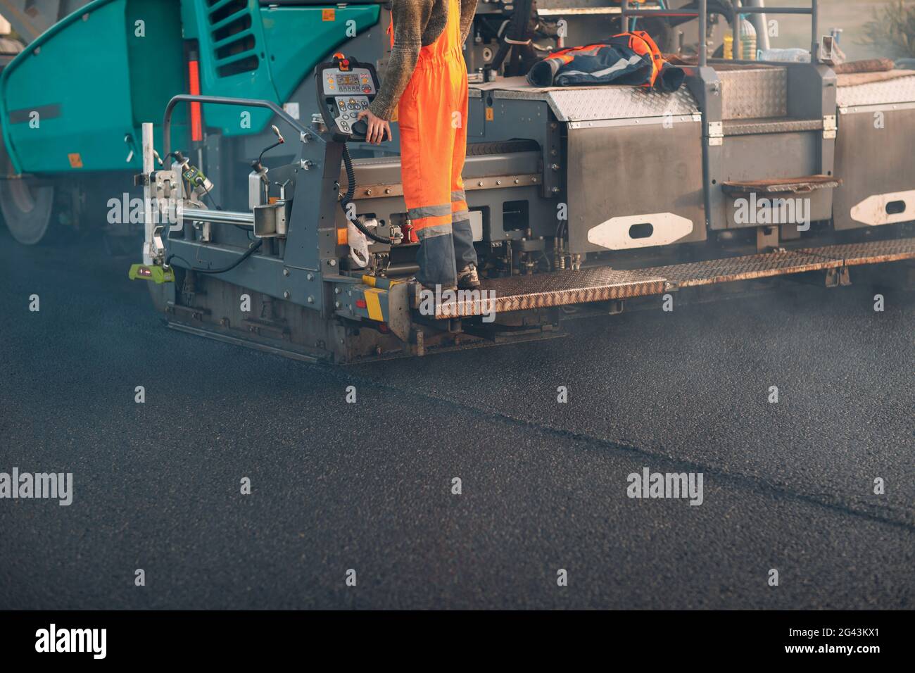 Asphalt paving. Paver machine. New road construction. Stock Photo