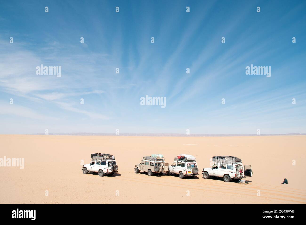 A convoy of Sahara desert safari 4x4 jeeps on the edge of the Great Sand Sea deep in the Western Desert Sahara region of Egypt. Stock Photo