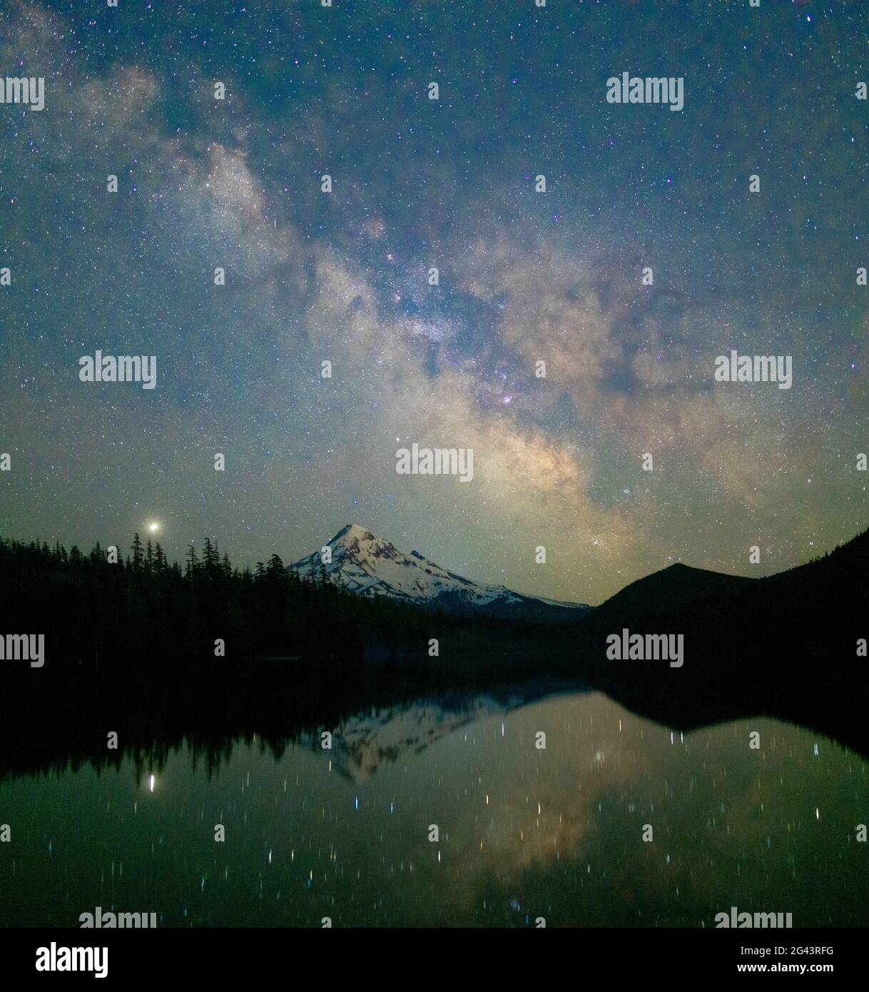 Milky Way and stars in sky at night above Mount Hood and Lost Lake, Oregon, USA Stock Photo