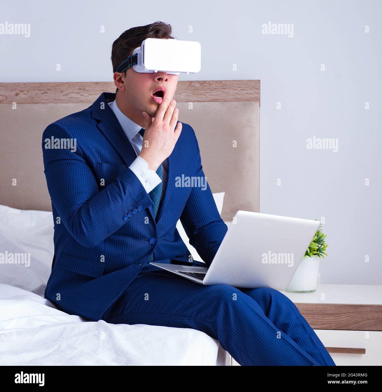 Businessman wearing a virtual reality headset in the bedroom Stock Photo