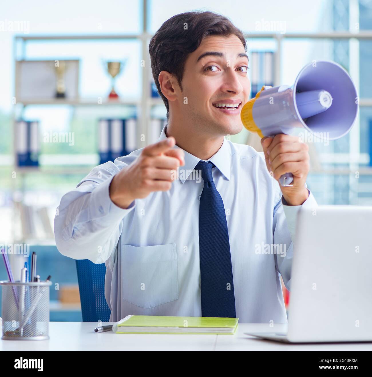 Travel agent announcing sales discounts with loudspeaker Stock Photo