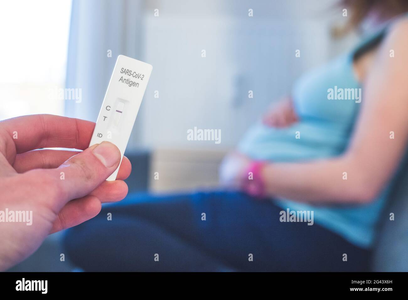 Coronavirus and Covid19 during pregnancy Close up of fingers holding a