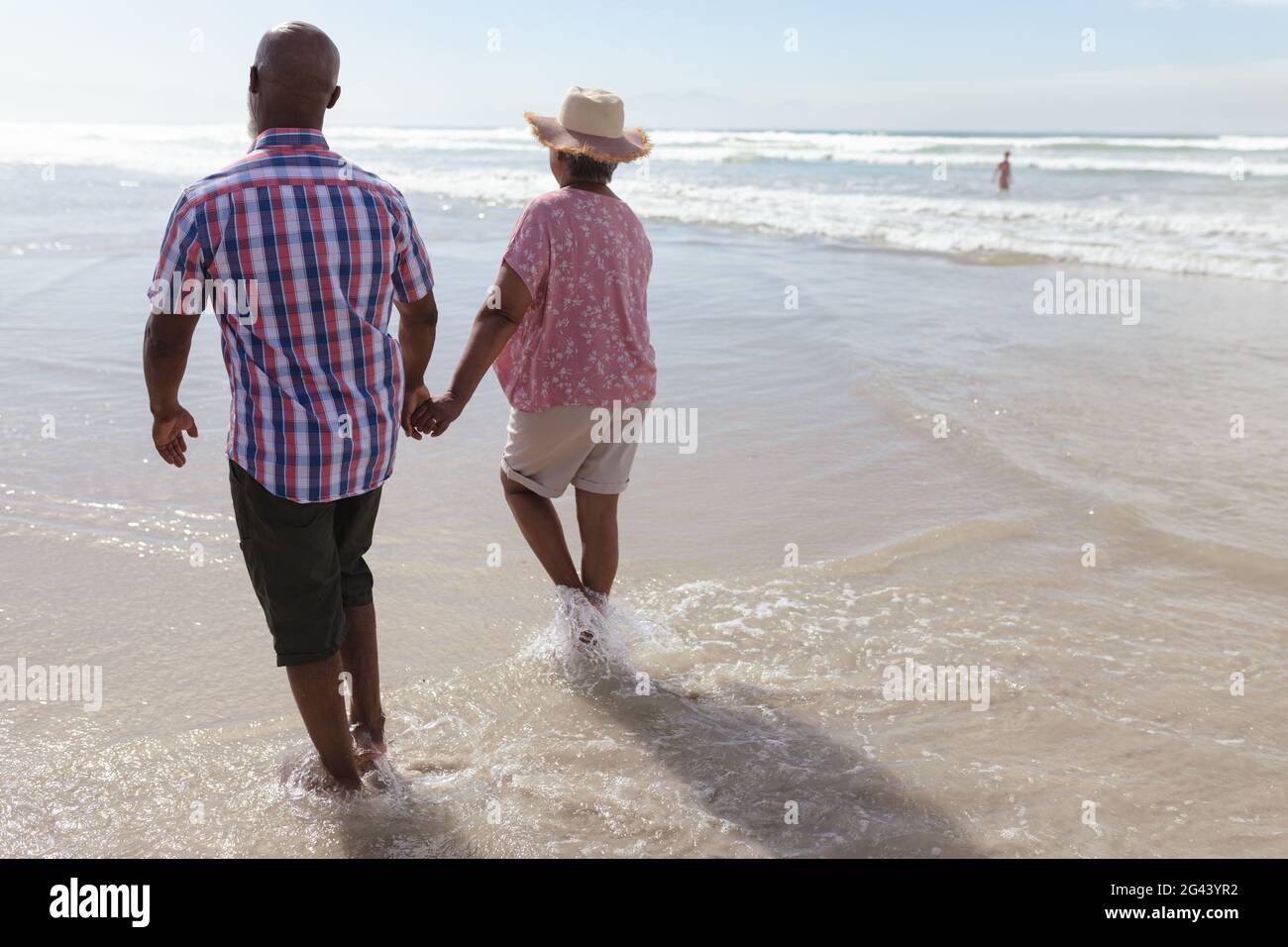 Senior african american couple holding hands walking on the beach Stock ...