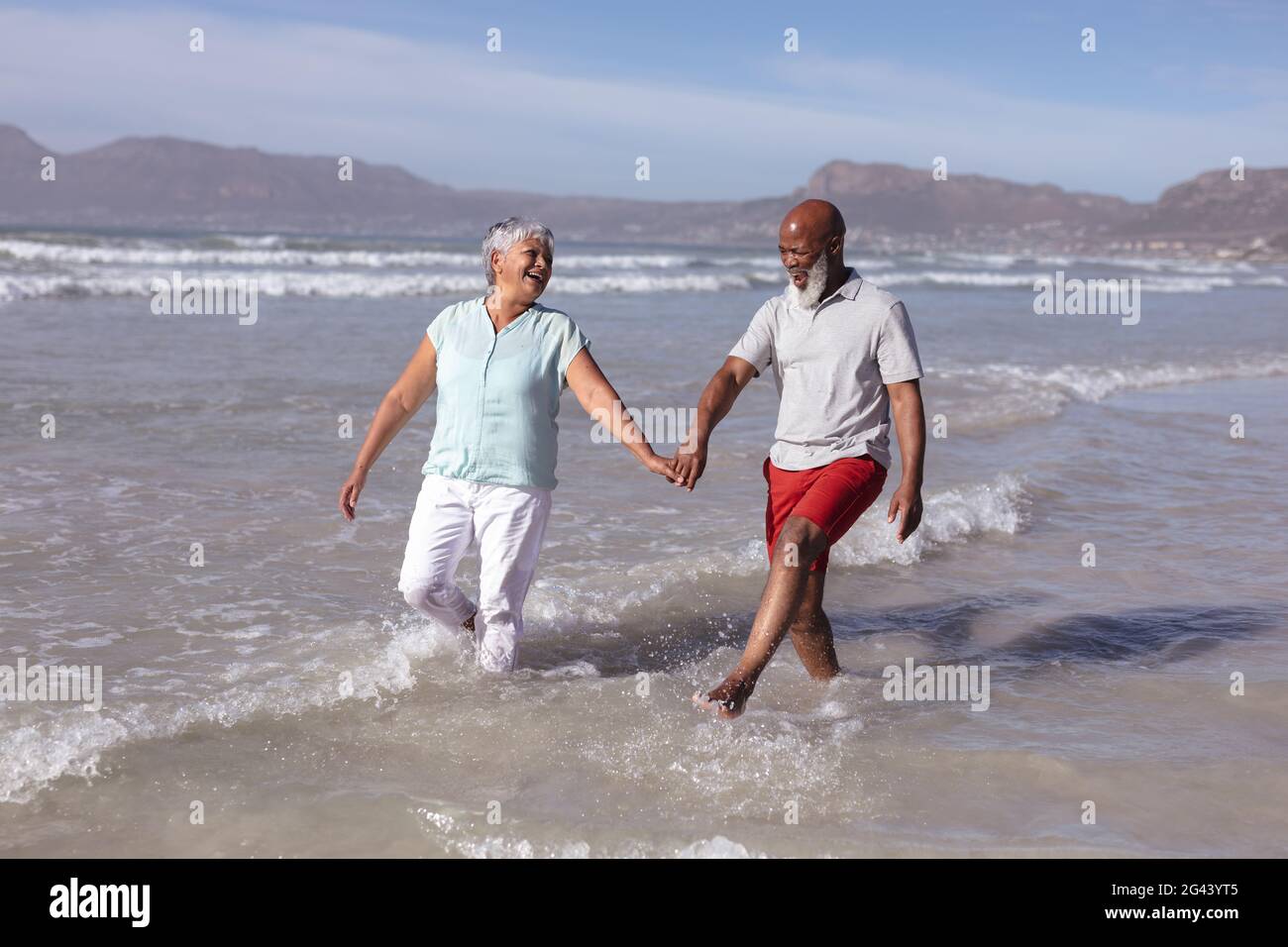 Happy senior african american couple holding hands and having fun on ...