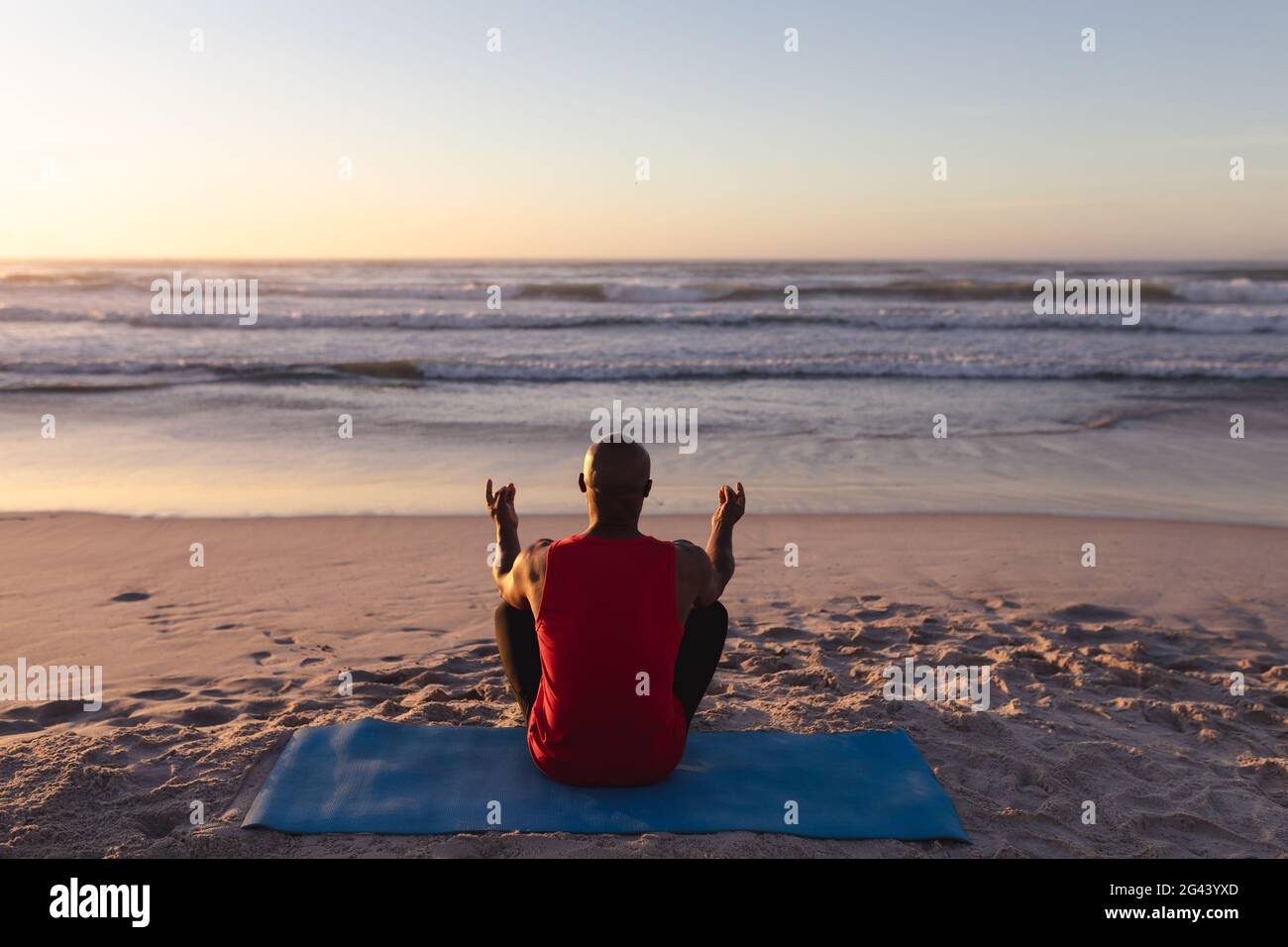 Rear view man meditating sitting hi-res stock photography and images ...