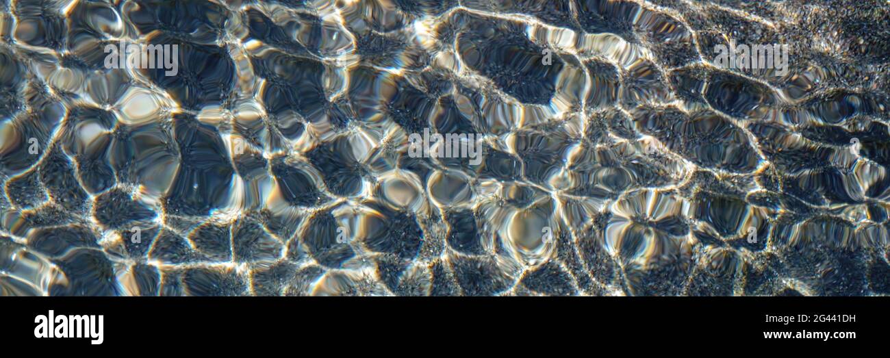 Pebble water caustics background with color refractions Stock Photo