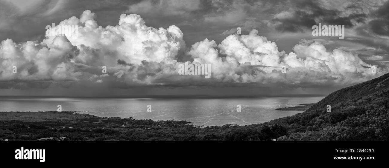 Cumulus clouds above Kealakekua Bay coast in black and white, Hawaii, USA Stock Photo
