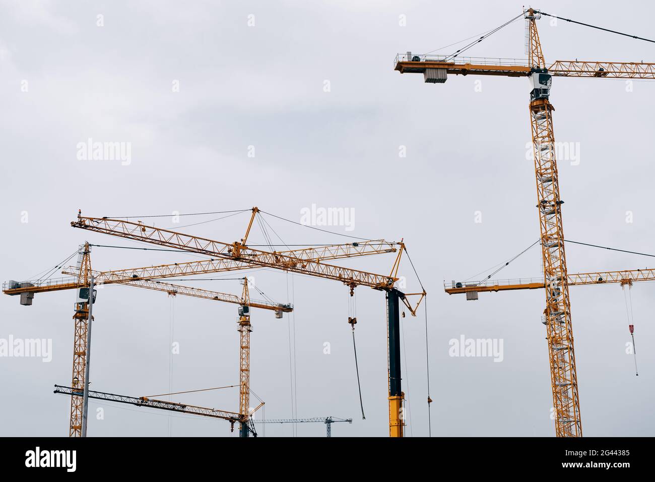 Huge cranes against the blue sky. Construction background Stock Photo ...