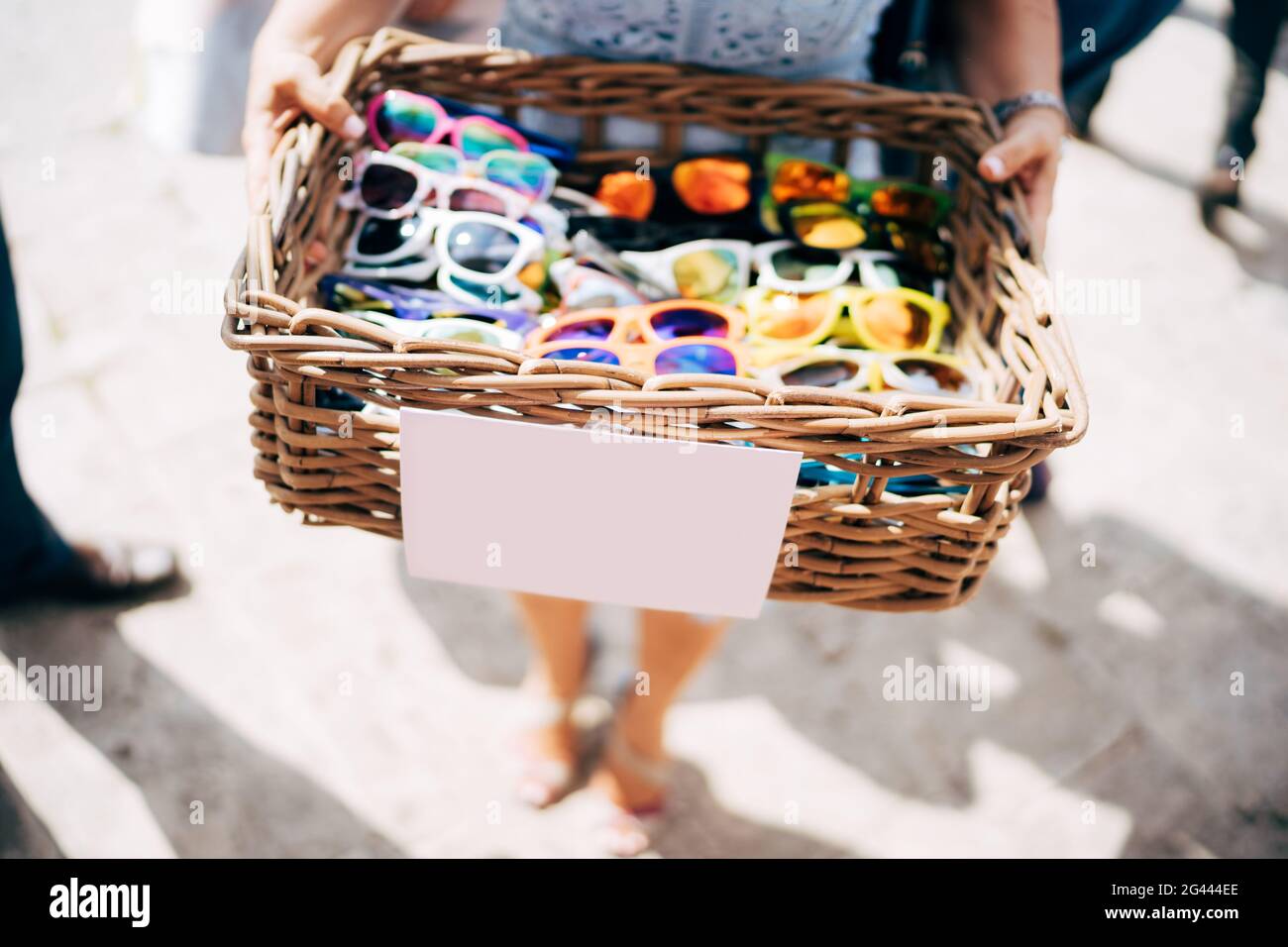 A basket of glasses. A wicker basket of wood with sunglasses of