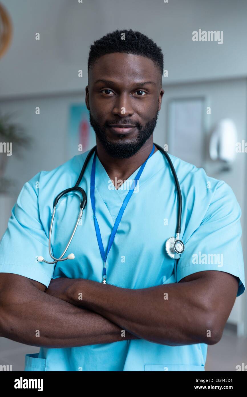 Portrait of african american male doctor with stethoscope wearing scrubs in  hospital Stock Photo - Alamy