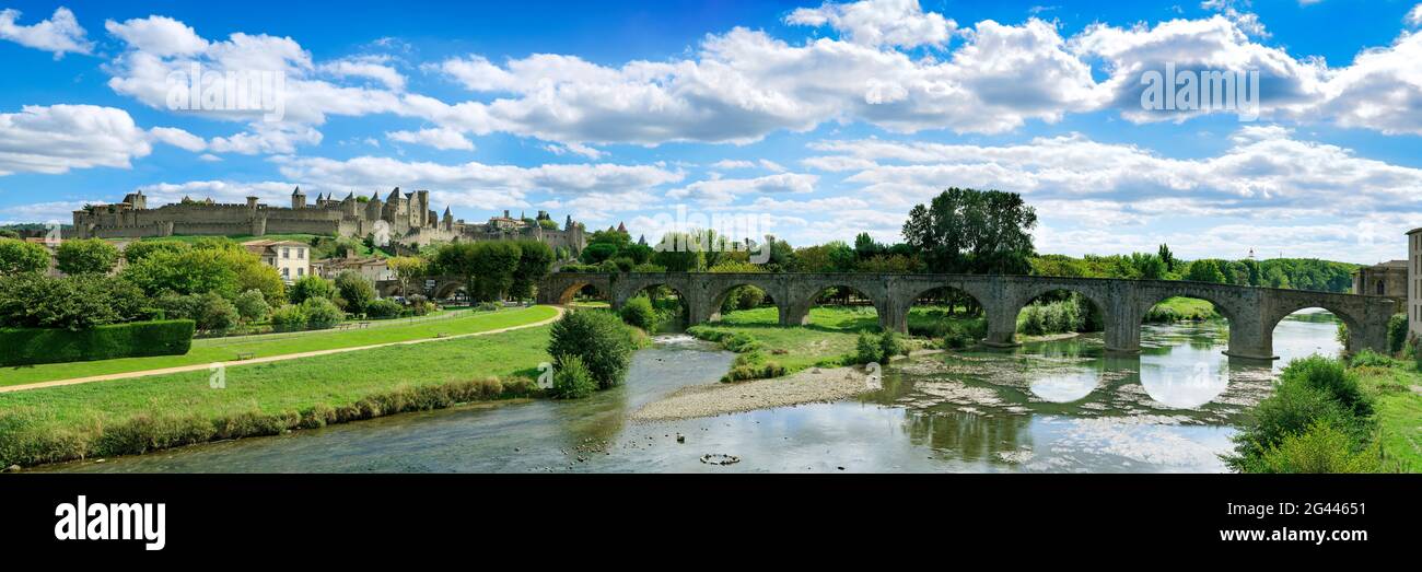 Landscape with old arch bridge across Aude River, Carcassonne, Occitanie, France Stock Photo