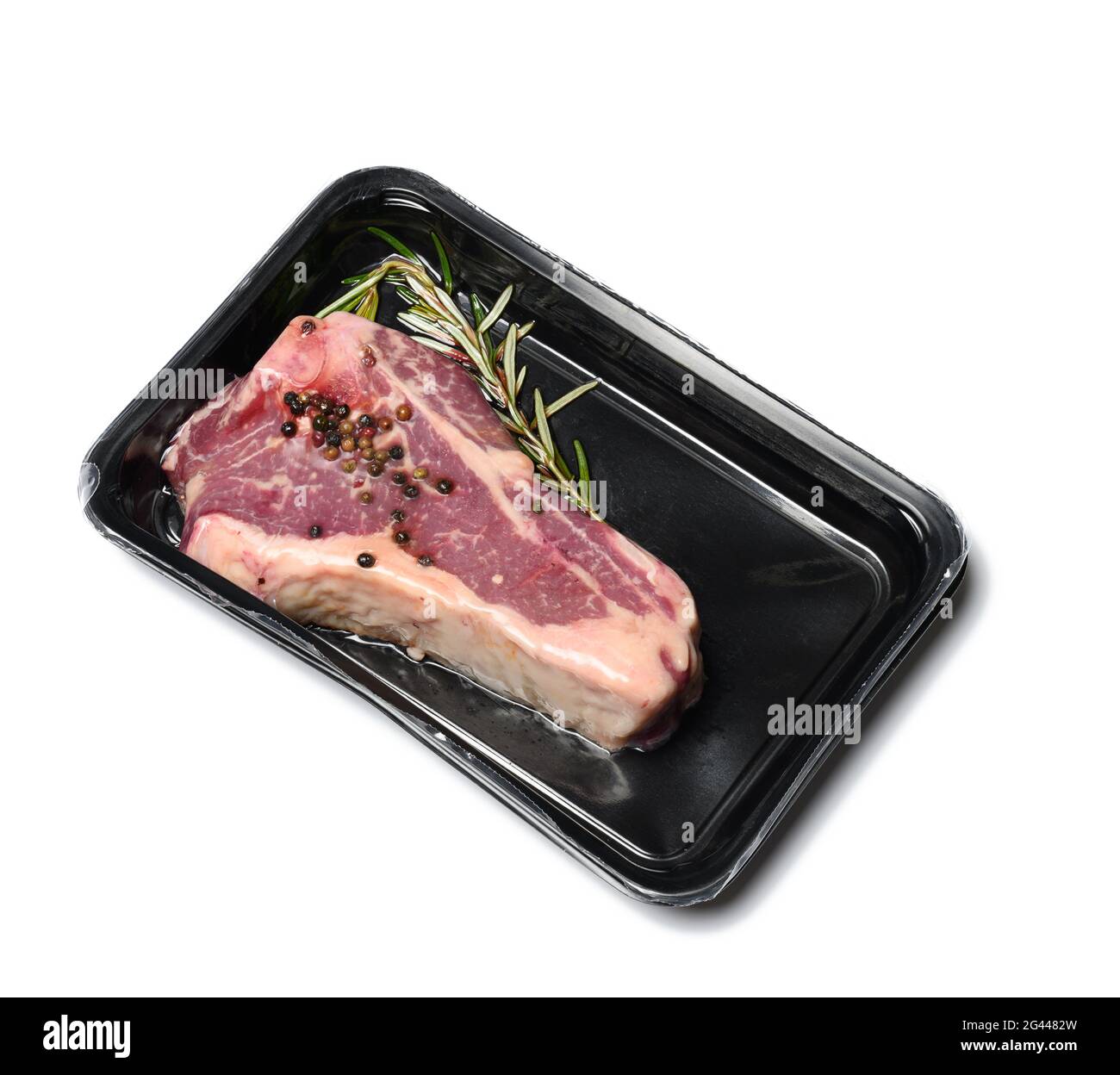 Raw New York beef steak is packed in a plastic container and vacuum