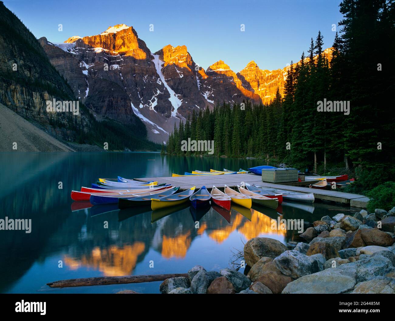 Canoes at Moraine Lake at Sunrise, Banff National Park, Alberta, Canada Stock Photo