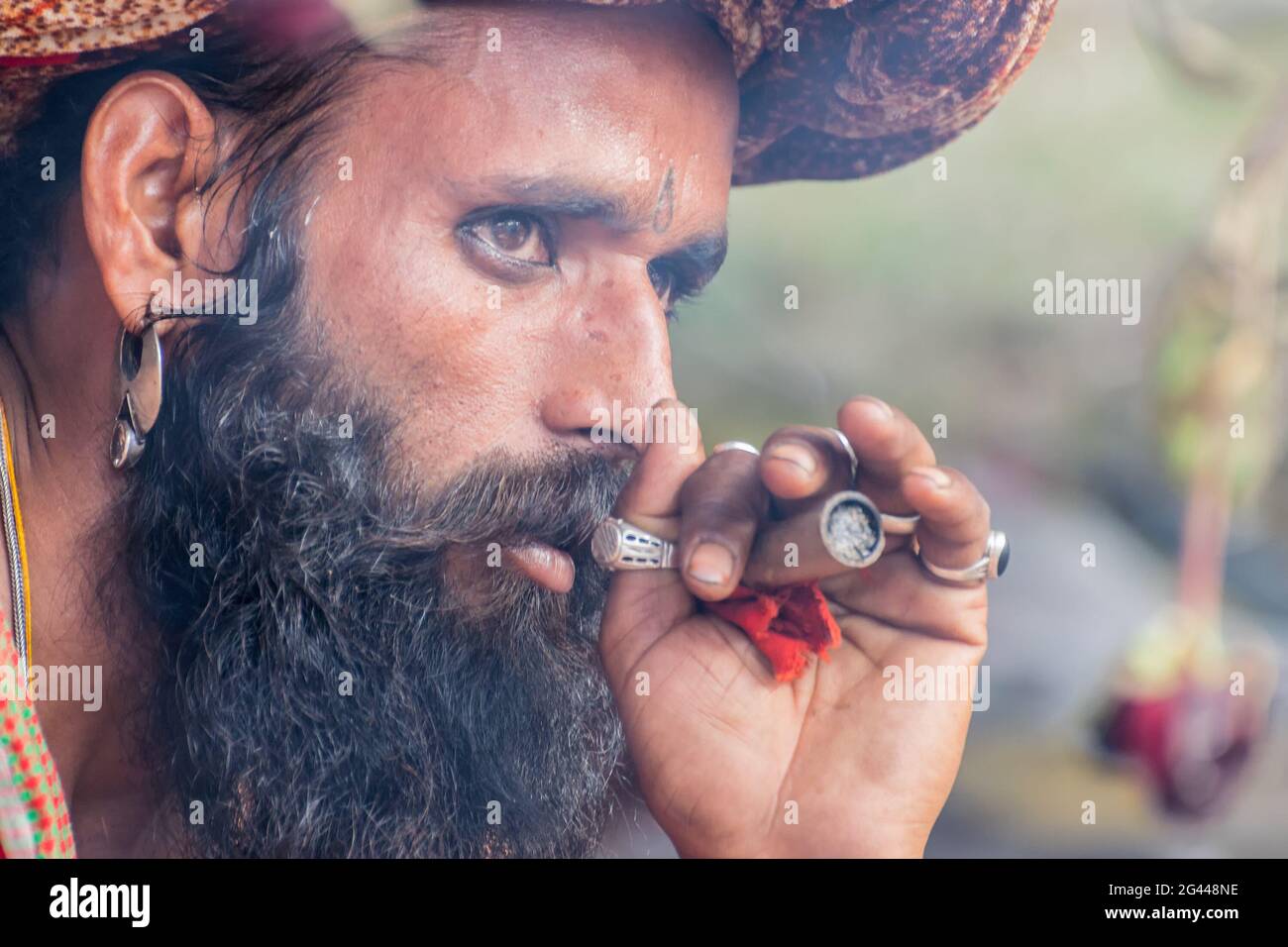 BABUGHAT, KOLKATA, WEST BENGAL / INDIA - 10TH JANUARY 2015 : Hindu Sadhu smoking marijuana, locally called Ganja, a form of canabis sativa . Stock Photo