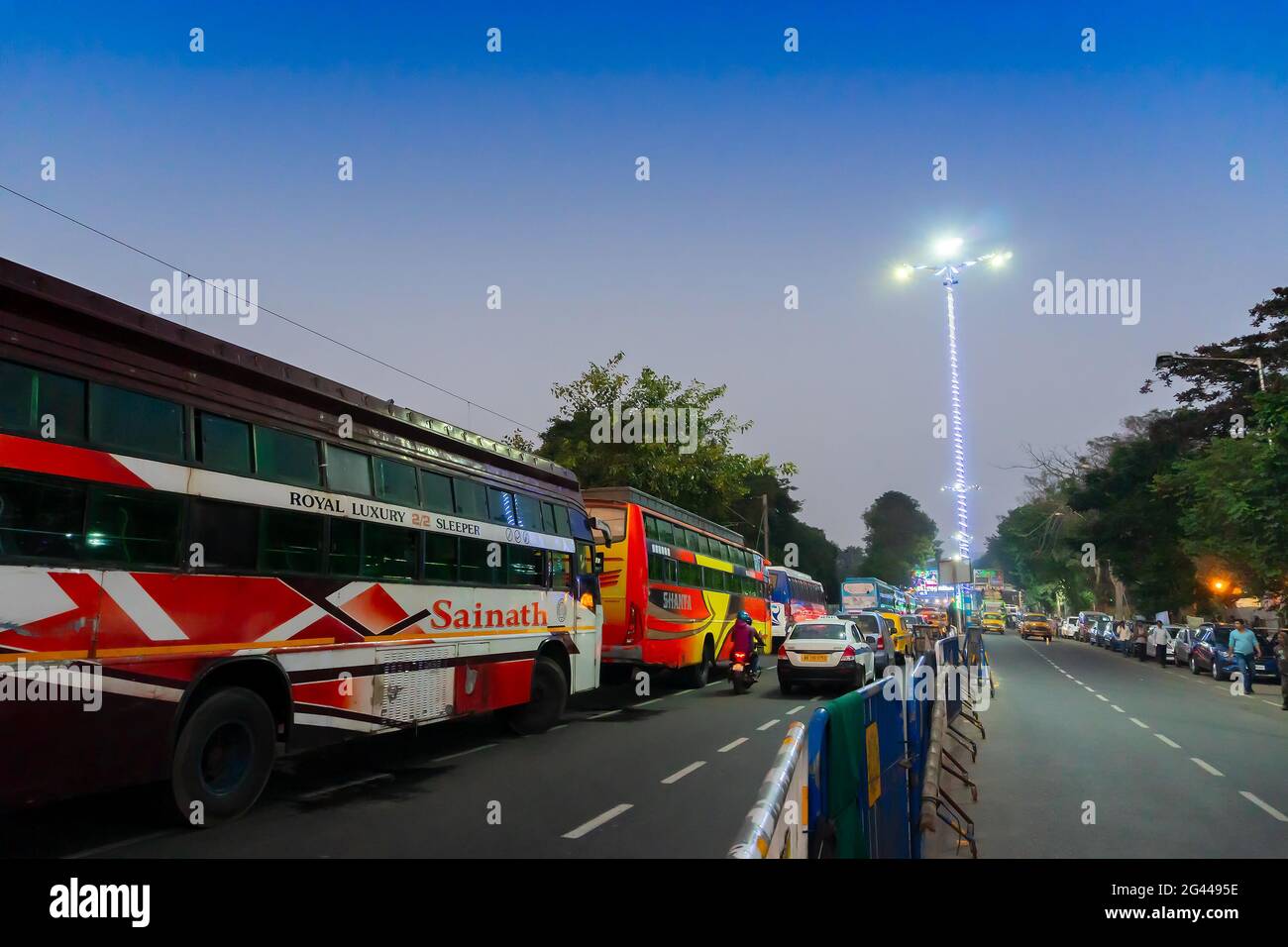 Kolkata, West Bengal, India - 12th January 2020 : Buses destined for Gangasagar, parked up beside Gangasagar Transit camp at Babughat, Kolkata, in the Stock Photo