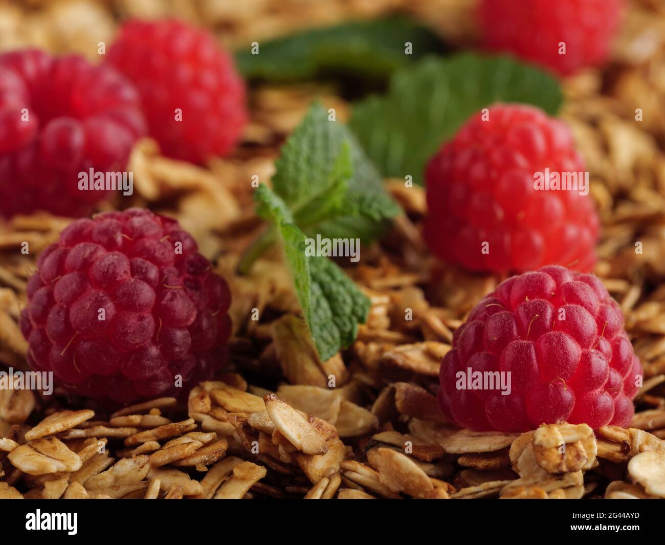 Horizontal Rasberries Raspberries lie on granola with mint leaves. Horizontal photo Stock ...