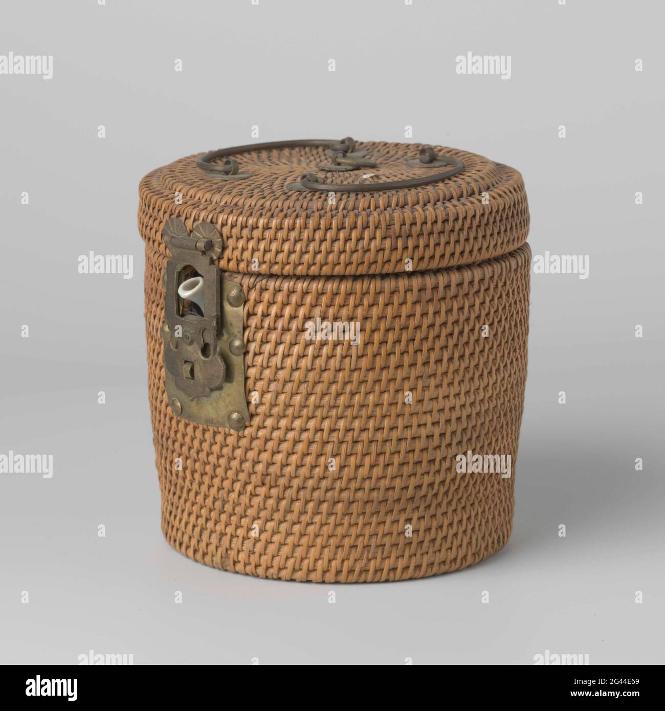 Wicker basket for teapot. Braided, drumshaped basket with brass hinges