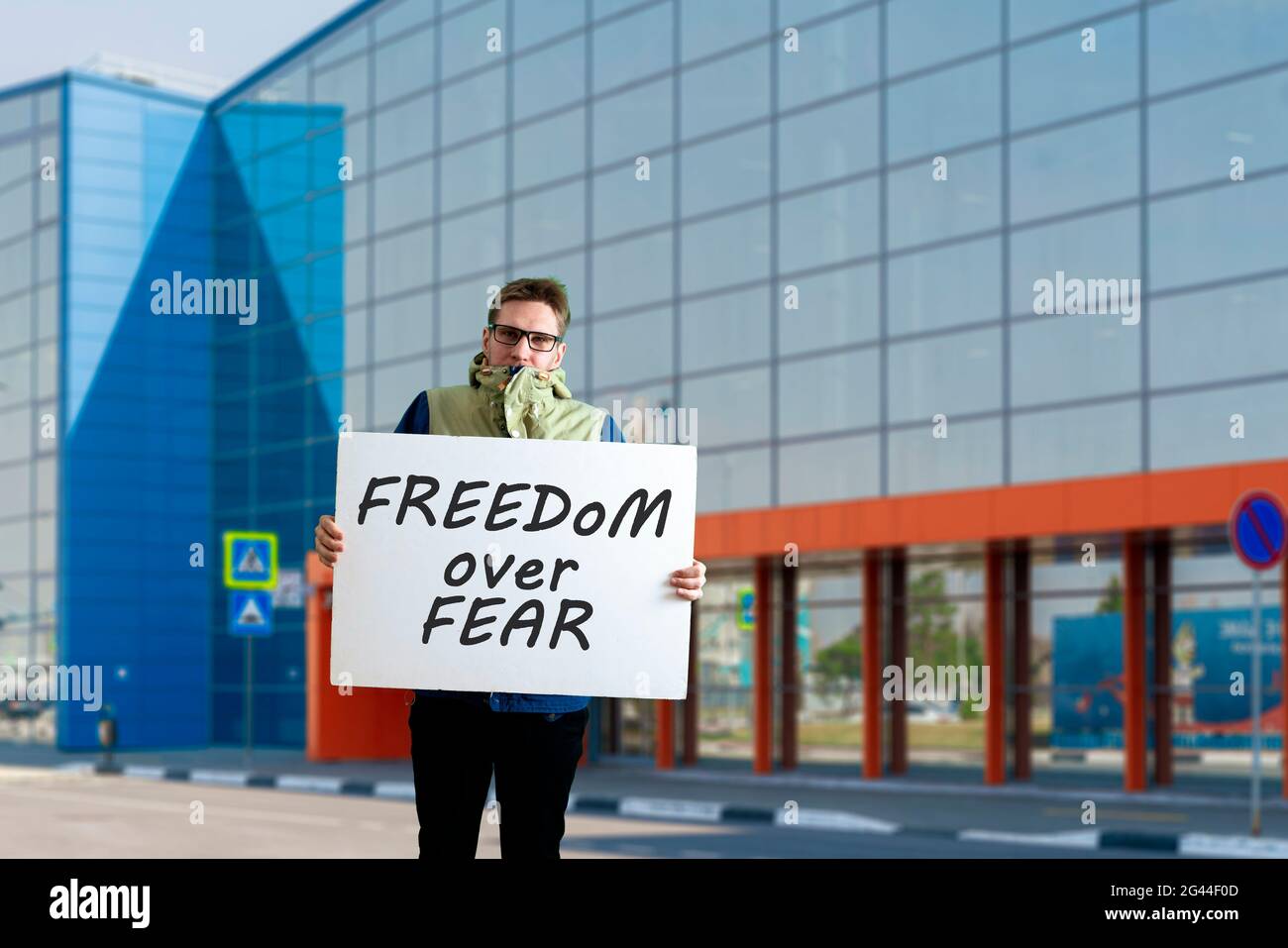 male young activist with cardboard, solo protest, political gesture ...