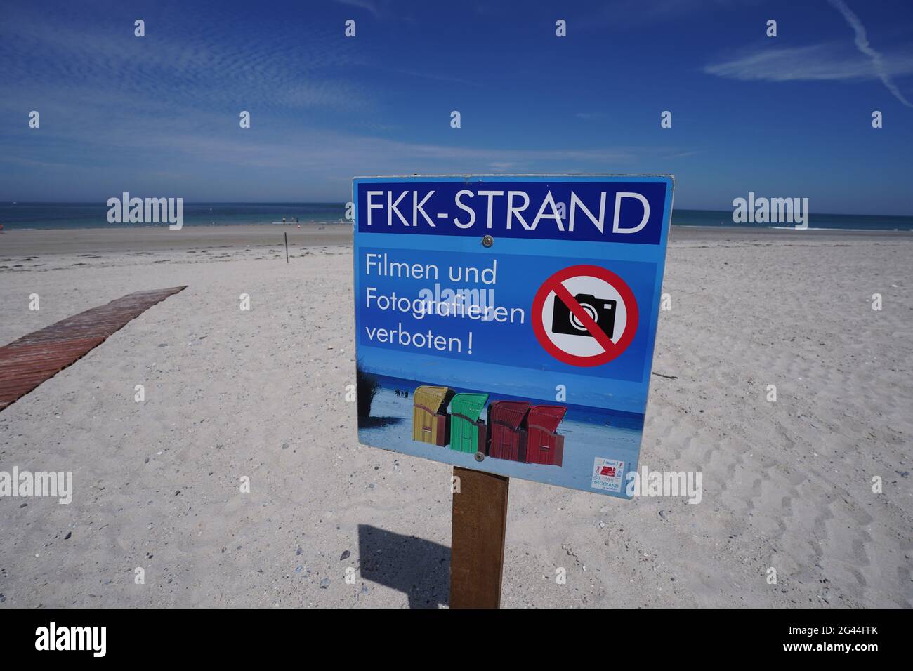 Helgoland, Germany. 16th June, 2021. A sign with the inscription FKK-Strand.  Filming and photography prohibited! is posted on the nudist beach on the  dune of the high seas island of Helgoland. (To