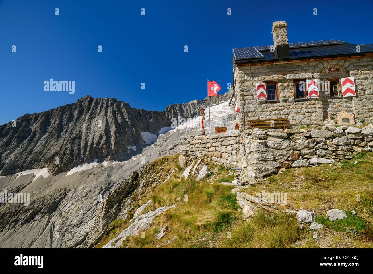 Hut Baltschiederklause with Swiss flag, Baltschiederklause, Bernese Alps, Valais, Switzerland Stock Photo