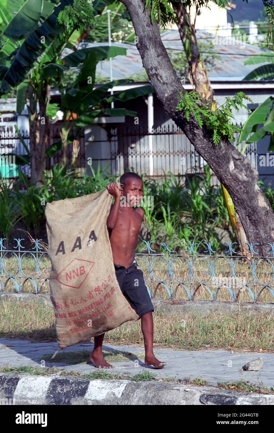 May 20, 2002-Dili, Timor-Leste-In This Photos taken Independence day scene and Timorese daily life on 7day in Dili and Atambua Village. A Boy walk finding recycle waste at district in Dili, Timor-Leste. Stock Photo