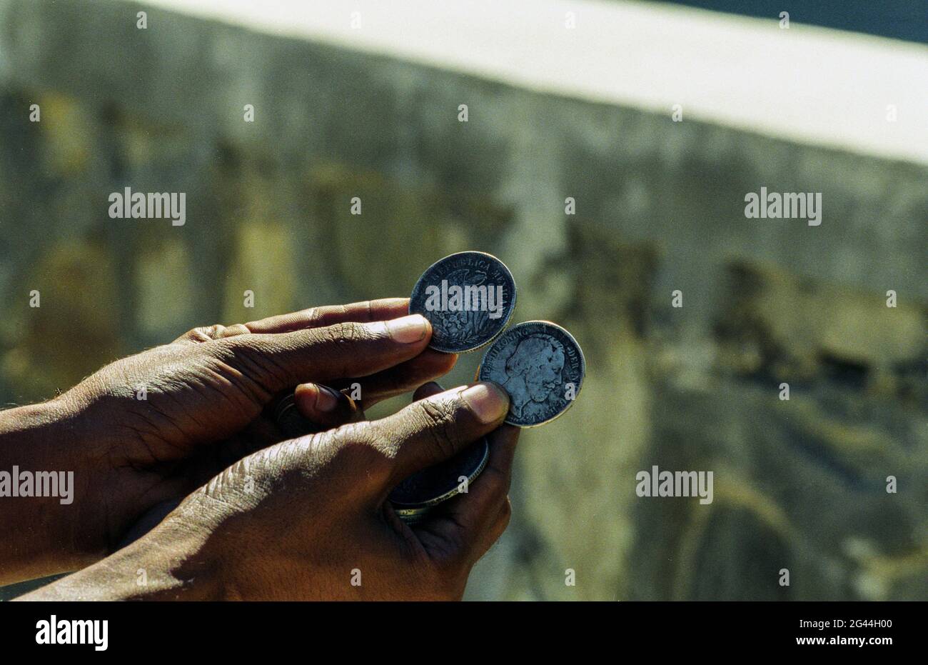 May 20, 2002-Dili, Timor-Leste-In This Photos taken Independence day scene and Timorese daily life on 7day in Dili and Atambua Village. Man hold show Timorese Coin at Comoro village, Timor-Leste. Stock Photo