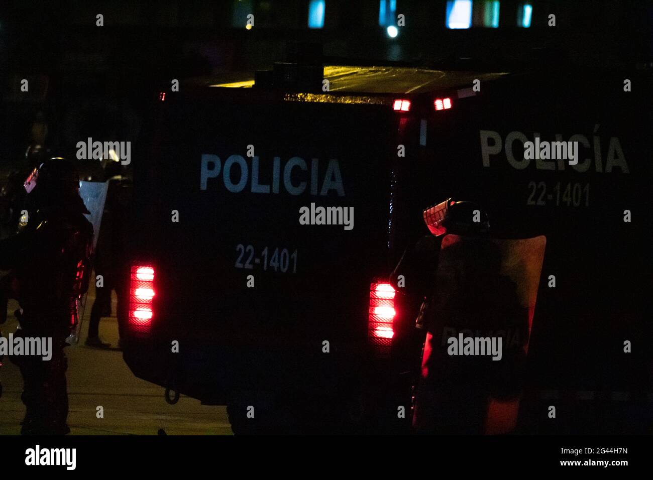 Bogota, Colombia. 17th June, 2021. A colombia's riot police officer (ESMAD) is backlit by an armored riot truck as cultural acts and demonstrations escalated later in the night to clashes betweem demonstrators and Colombia's riot police (ESMAD) admist anti-government protest against president Ivan Duque, on June 17, 2021 in Bogota, Colombia. Credit: Long Visual Press/Alamy Live News Stock Photo