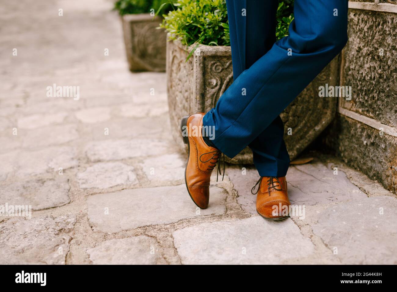 Groom feet on the background of a stone wall Stock Photo