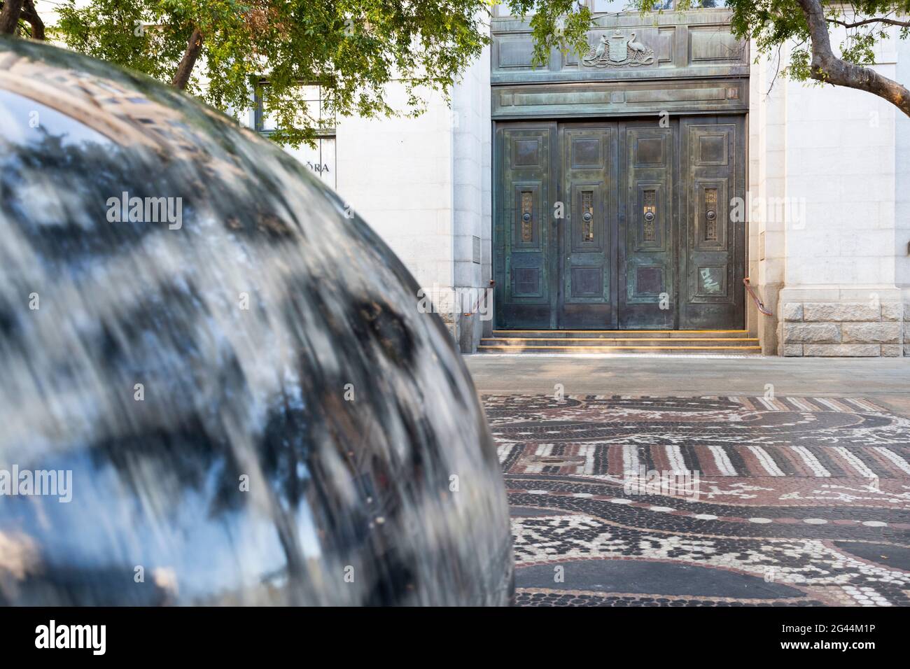 Rotating blurred rock sphere in Forrest Chase with historic doorway. Stock Photo