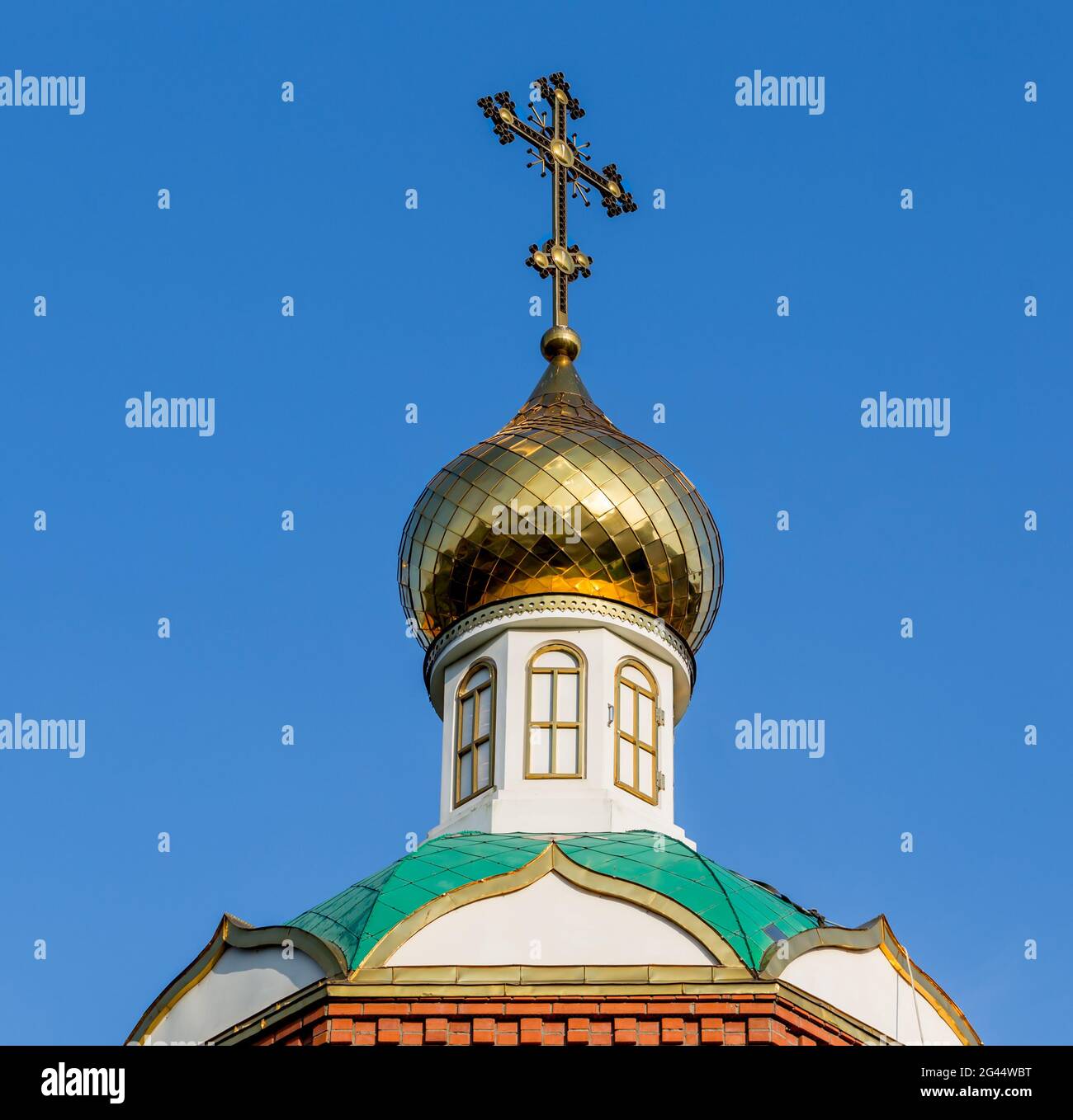 Orthodox cross on the roof of the church in a sunny day. Stock Photo