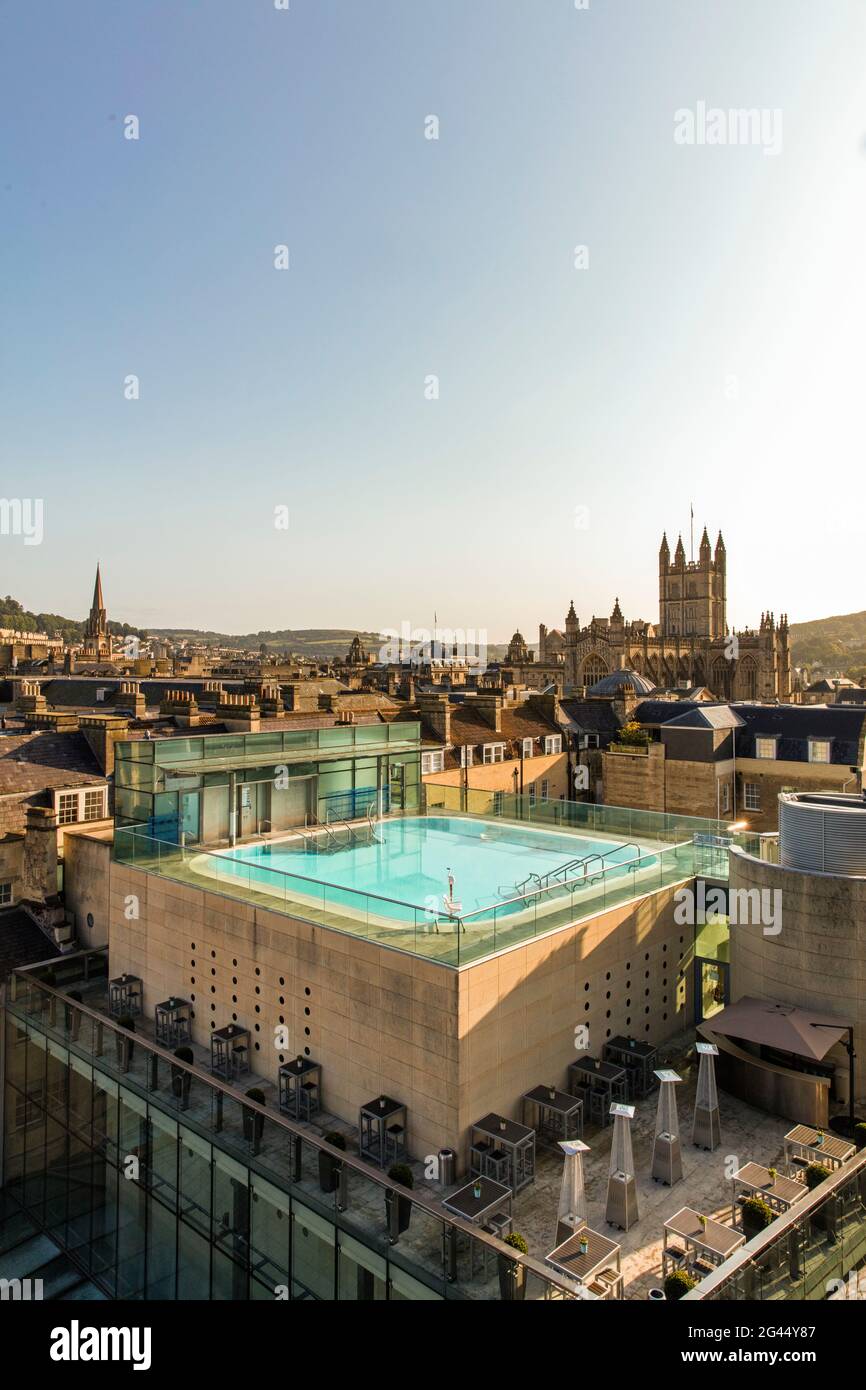 View of exterior roof-top pool set against the scenery of old turrets and buildings. Vertikal. Bath. United Kingdom Stock Photo