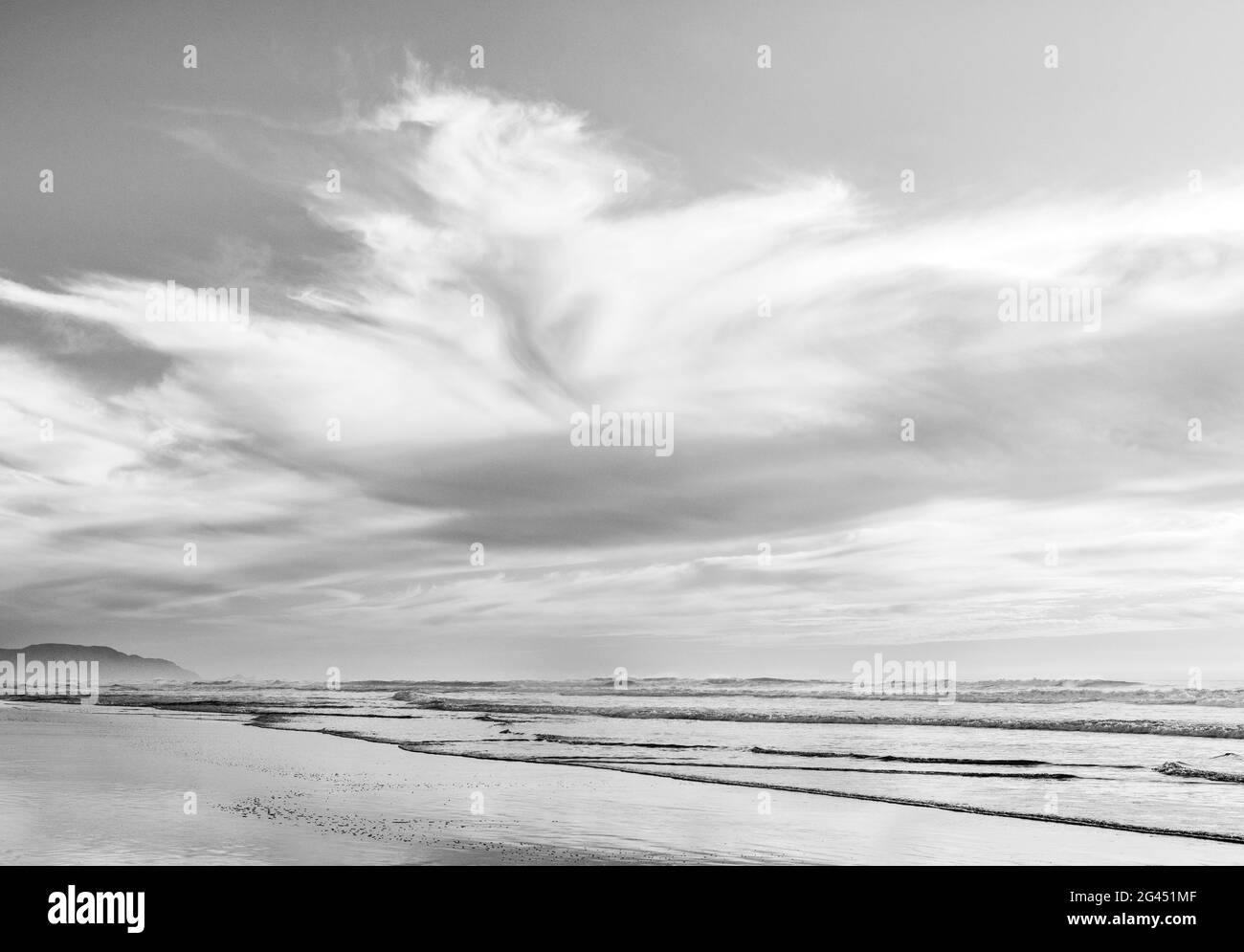 Landscape with beach, Pacific Ocean and Clouds in black and white Stock Photo