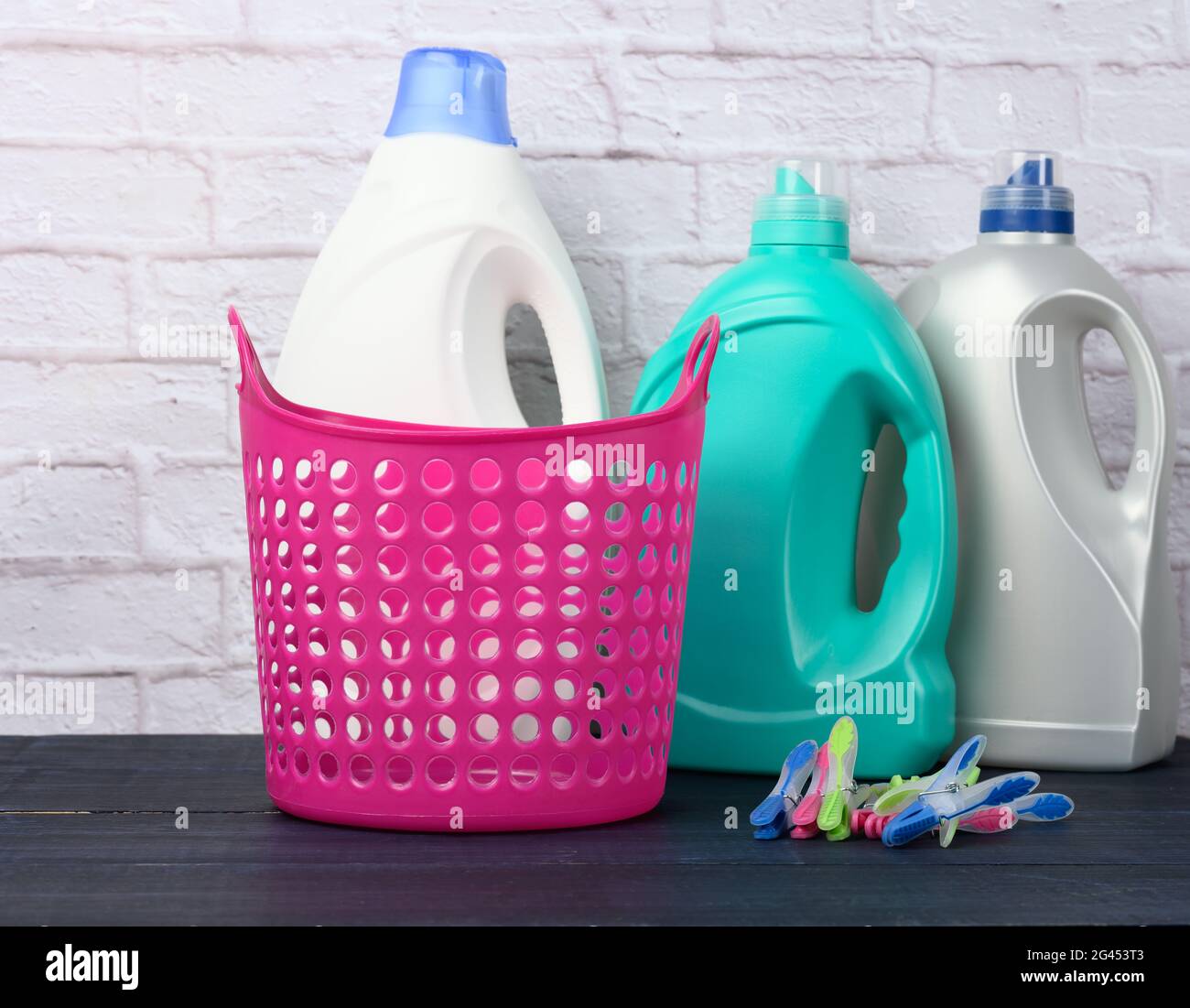 Empty pink laundry basket and plastic bottles with liquid detergent Stock Photo Alamy