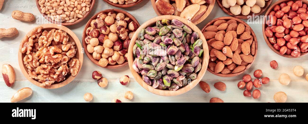 Nut panorama. Various nuts, shot from the top on a rustic background Stock Photo
