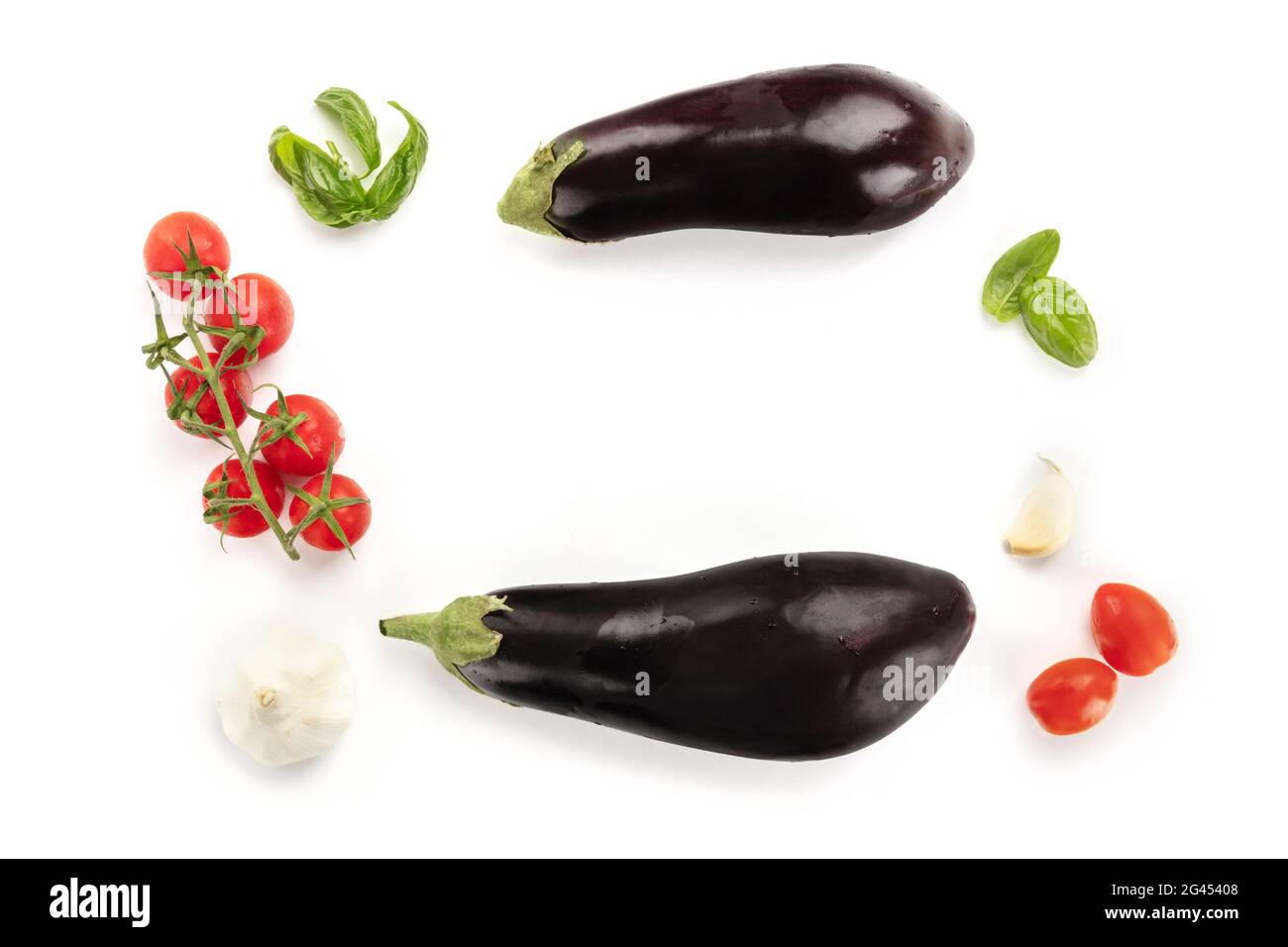 A flat lay composition with vegetables. Eggplants, tomatoes, basil and garlic Stock Photo