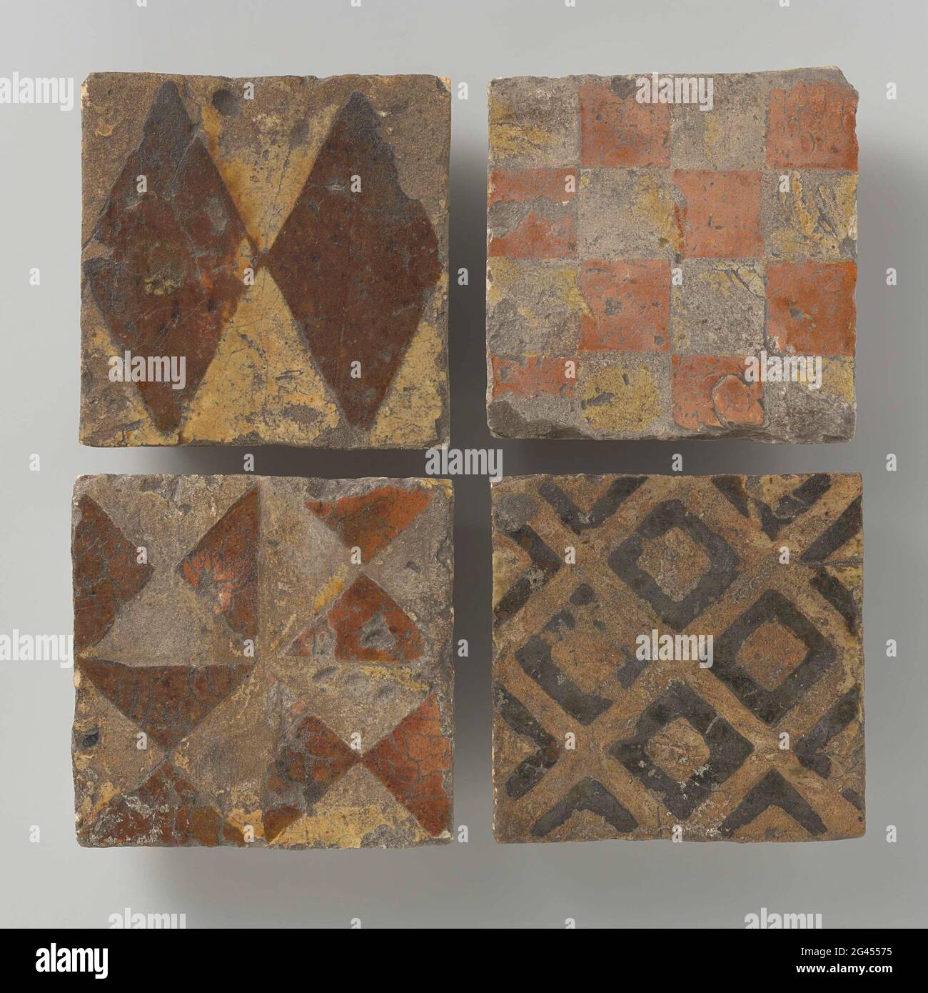 Four tiles decorated with different checks of patterns. Four tiles ...